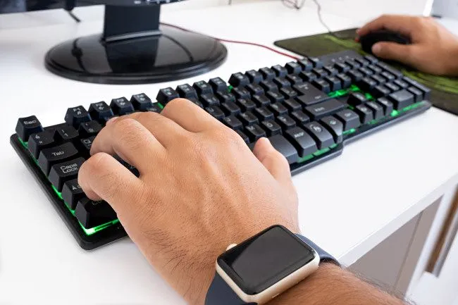 Hình ảnh game thủ tập trung sử dụng chuột và bàn phím WASD, biểu tượng cho trải nghiệm gaming thông thường