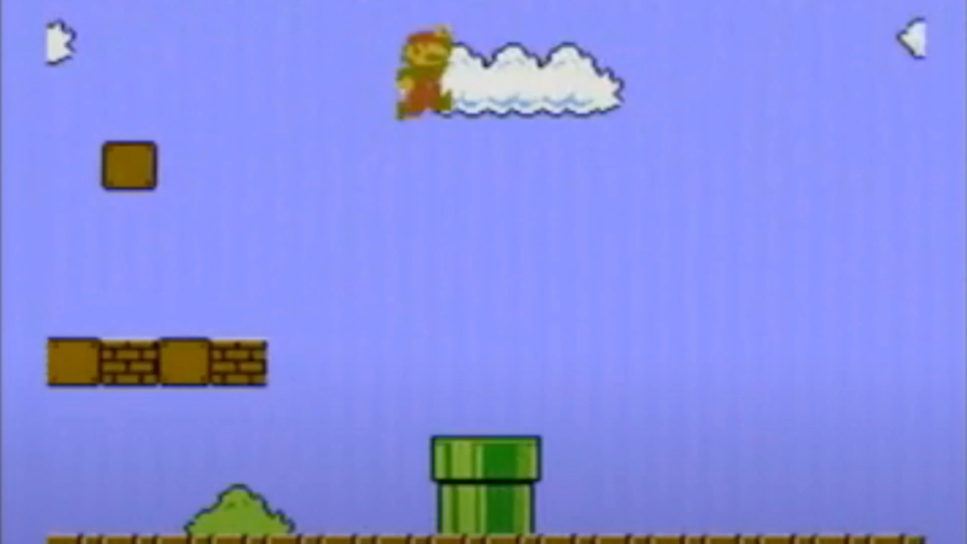 Mario nhảy trên các khối gạch và chạm vào khối hỏi chấm trong một màn chơi của Super Mario Bros., thể hiện lối chơi platformer cổ điển.
