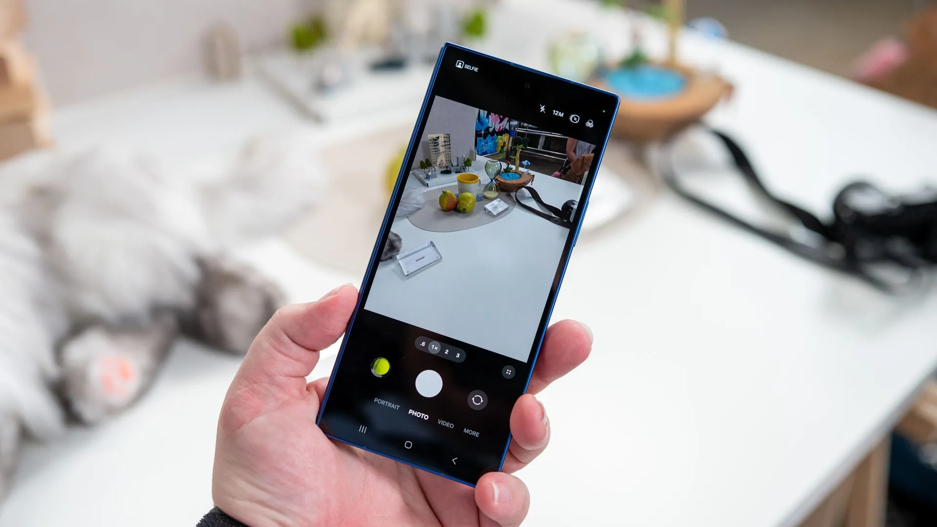 Một người cầm điện thoại Samsung Galaxy Z Fold 7 gập lại, hiển thị ứng dụng camera