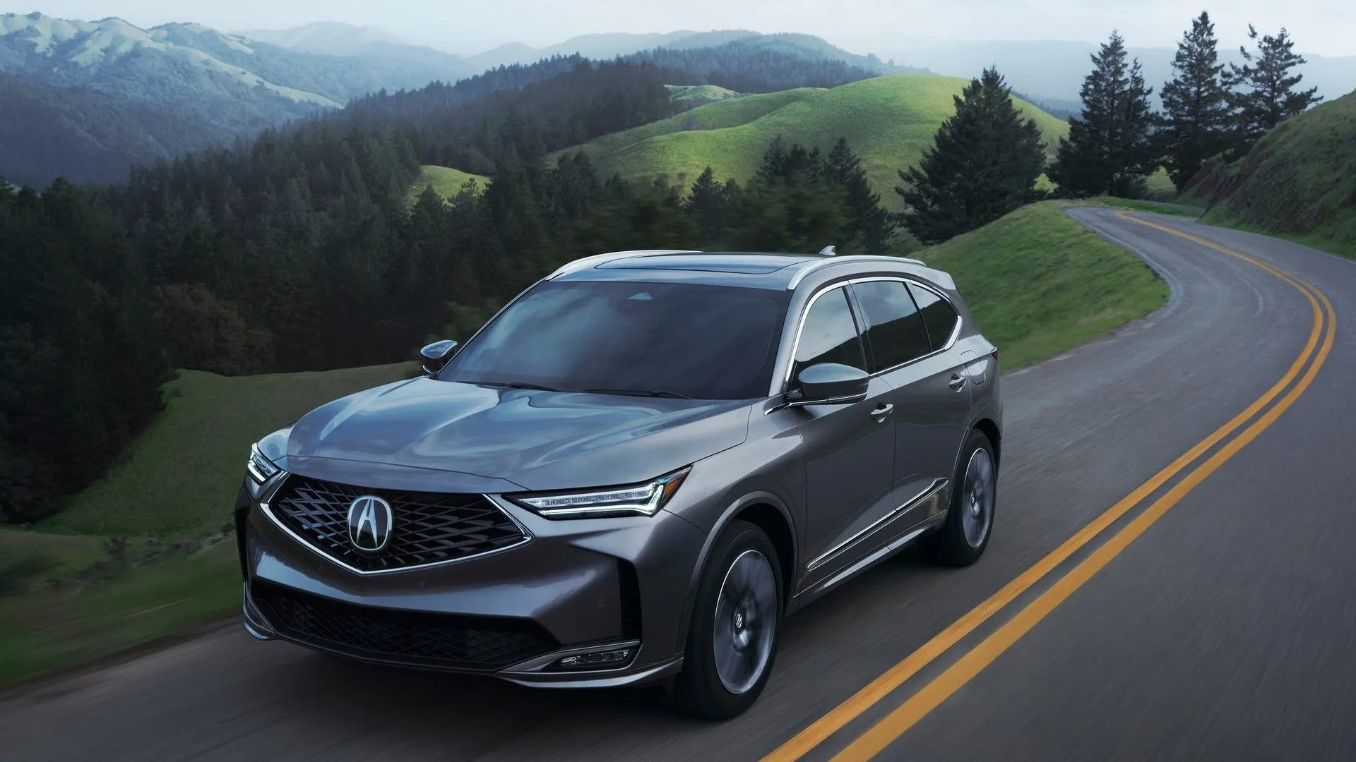 Acura MDX 2025 màu trắng đang di chuyển trên đường, mẫu SUV hạng sang cỡ trung
