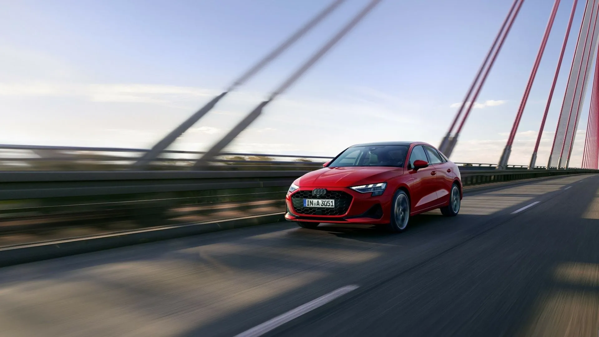 Audi A3 2025 màu xanh ngọc lam đang di chuyển năng động trên đường, nhấn mạnh thiết kế thể thao và trẻ trung