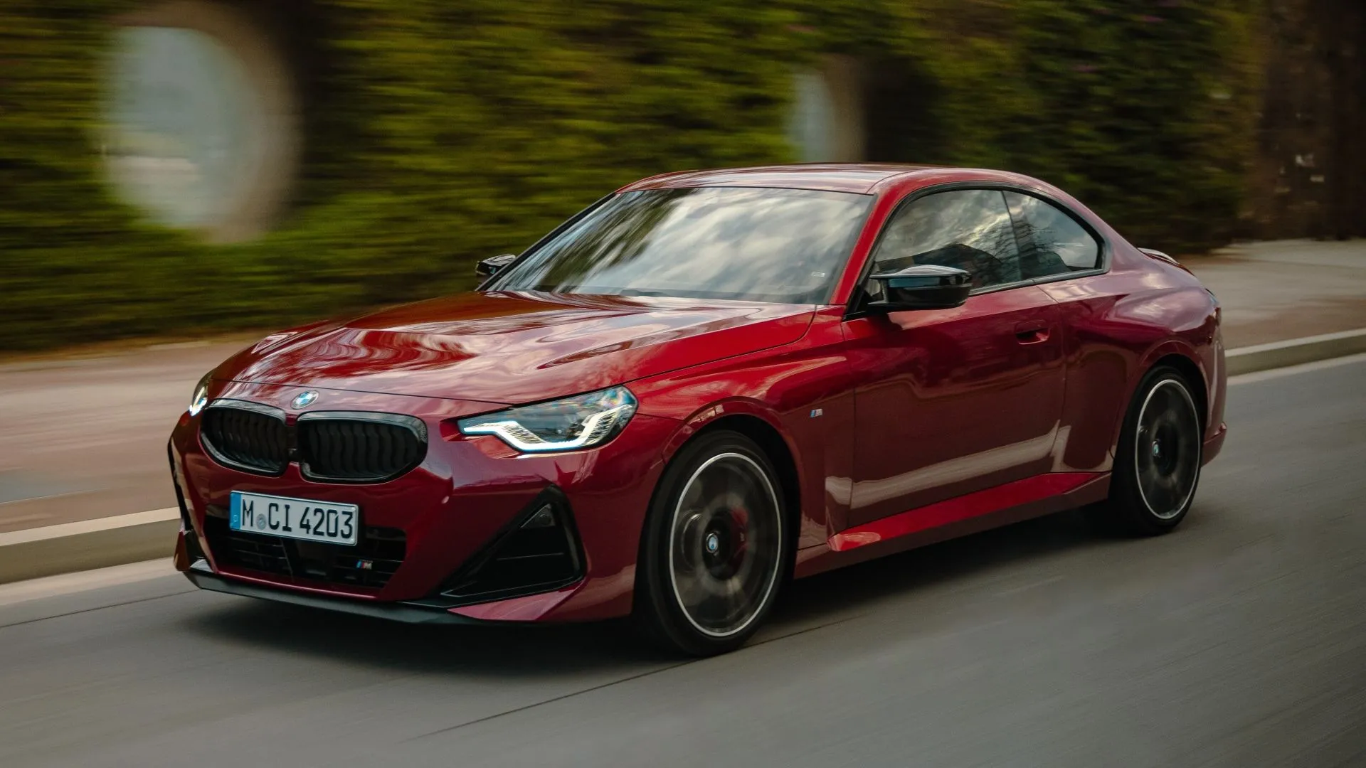 BMW 2-Series Coupe M240i 2025 màu xanh dương đậm, góc 3/4 phía trước đầy mạnh mẽ
