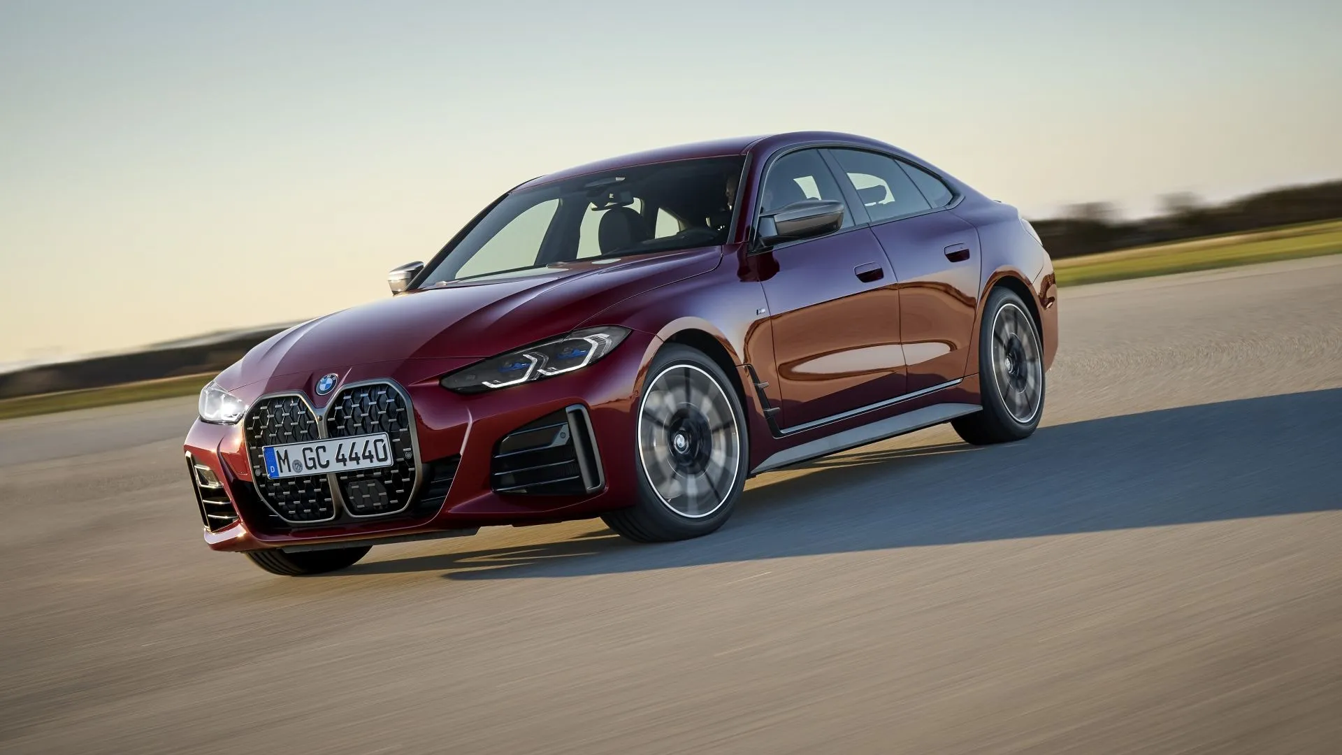 BMW 4-Series Gran Coupe 2025 màu xám than đang di chuyển tốc độ cao, làm nổi bật kiểu dáng fastback và sự năng động