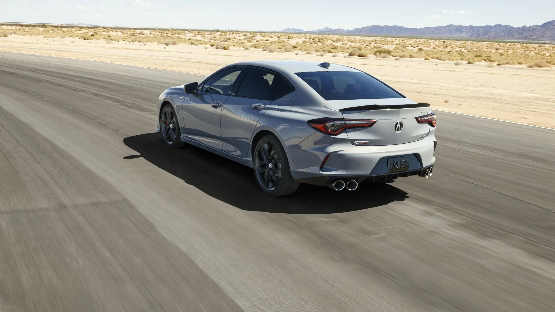 Hình ảnh Acura TLX Type S 2024 đang di chuyển trên đường, thể hiện thiết kế thể thao và năng động