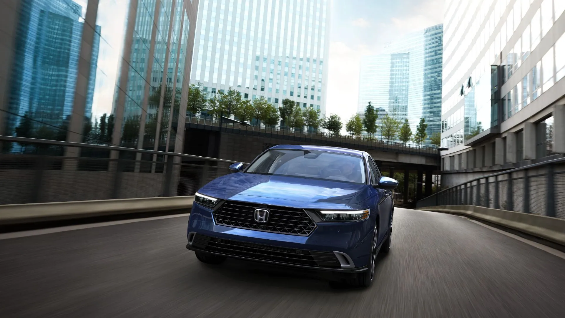 Honda Accord Touring 2023 màu xanh năng động di chuyển qua khu đô thị