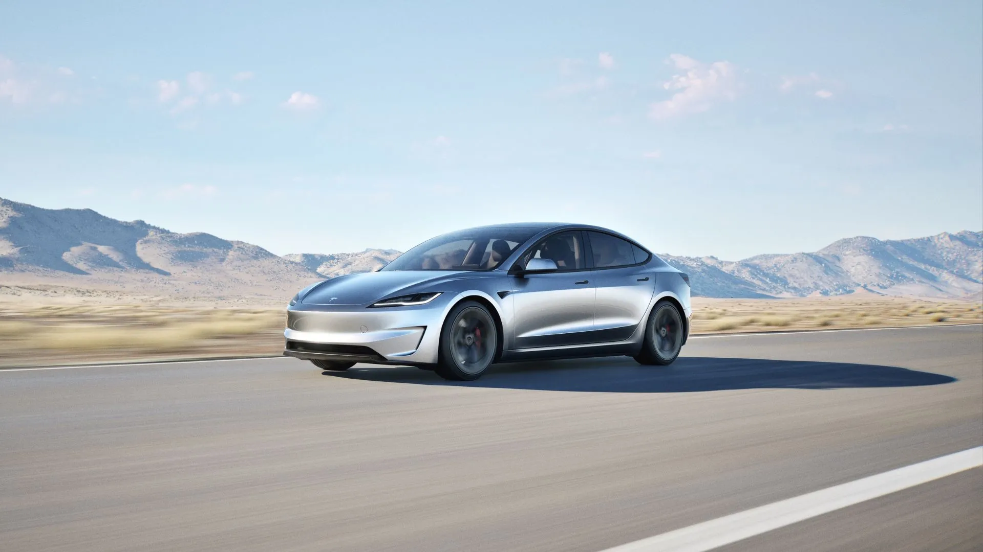 Tesla Model 3 Performance màu bạc chạy trên đường núi, minh họa cho hiệu suất vượt trội và thiết kế thể thao của mẫu xe điện.