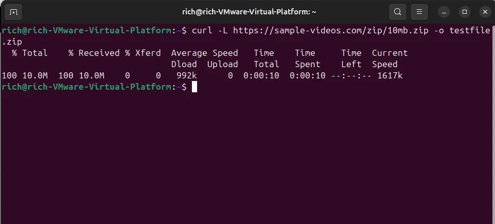 Ví dụ sử dụng lệnh curl -L để tải file zip dung lượng 10MB và lưu dưới tên testfile.zip trong terminal Linux.