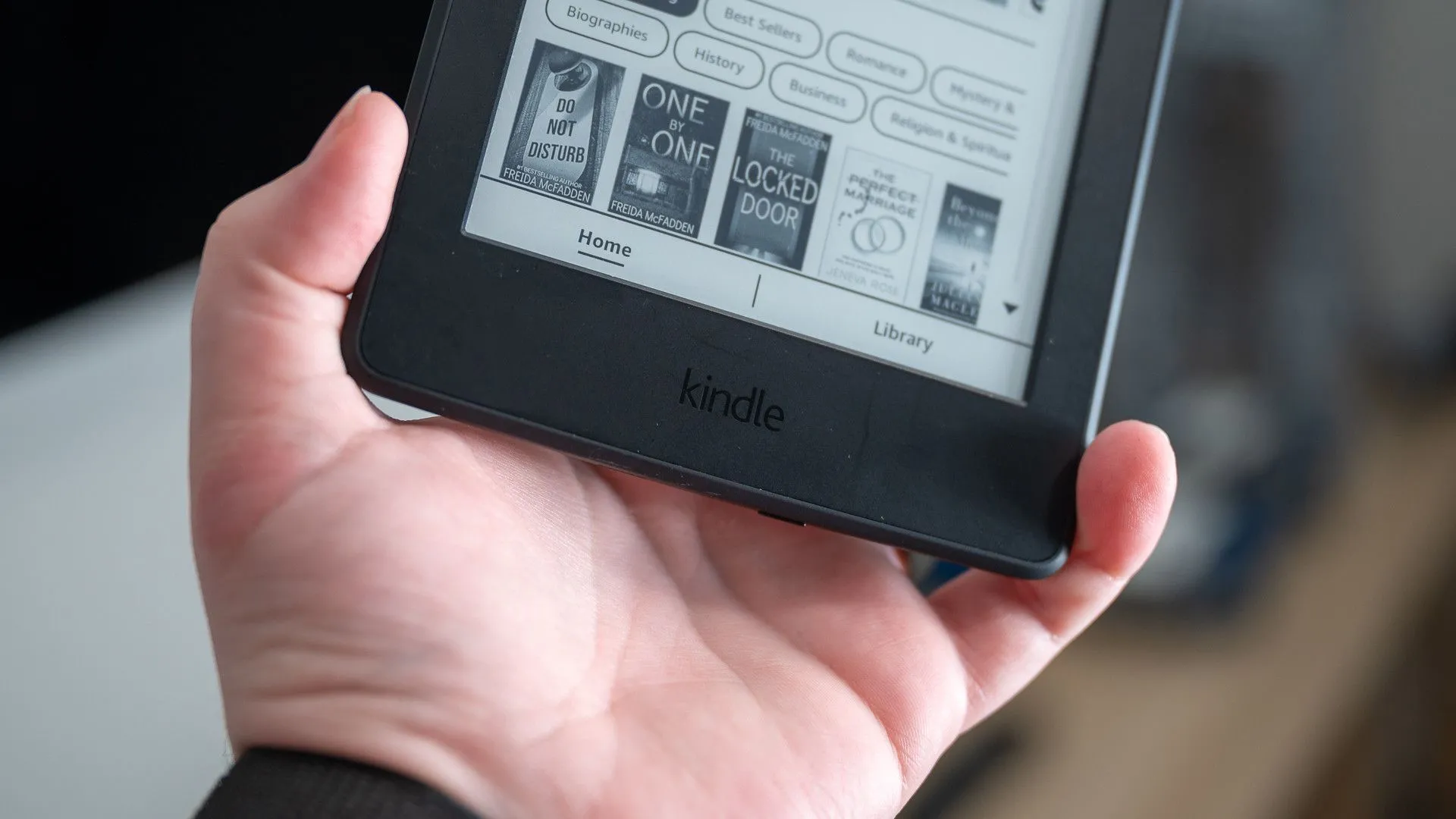 Logo Kindle trên mặt trước của thiết bị đọc sách Amazon Kindle Paperwhite 2015, biểu tượng của thương hiệu.